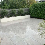 Paved patio area with hedges